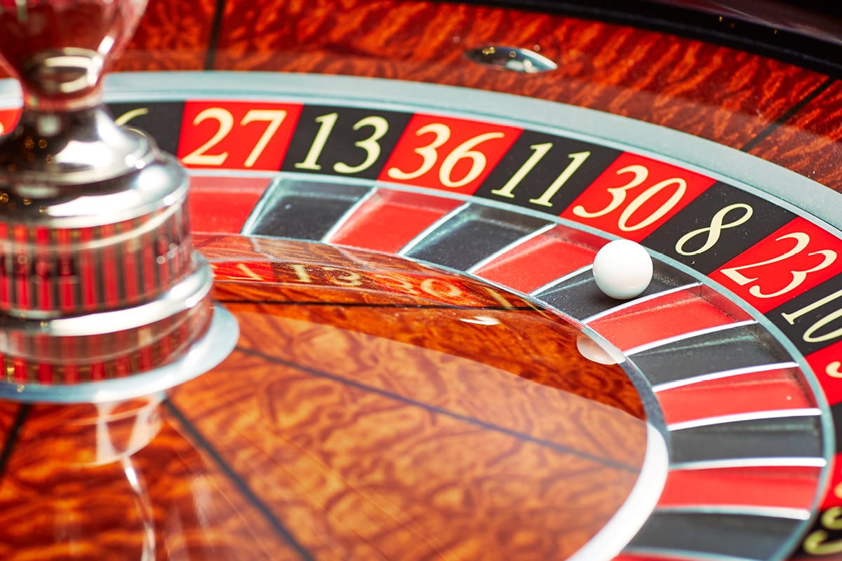 Roulette wheel spinning on a green felt casino table representing crown casino online live dealer games